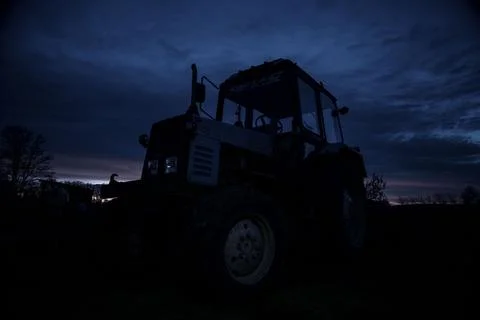 Old tractor on the background of the starry sky Stock Photos