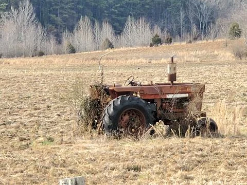 Old tractor in field Stock Photos