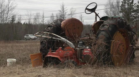 Old Tractor in a Field by a Road. Stock Footage 62512296