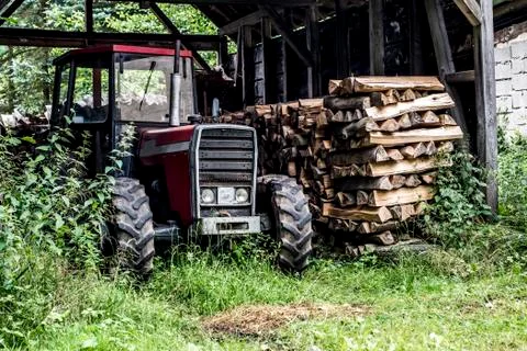 Old tractor front view in germany countryside old abandoned barn firewood woo Stock Photos