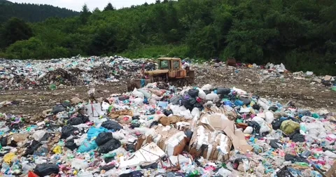 Old tractor at a landfill. Huge dumps of plastic garbage. Ecological catastrophe Stock Footage 172448428
