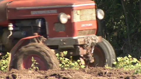 Old tractor passes through the field and plow Stock Footage 35452545