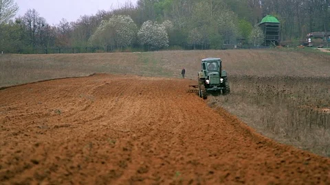 Old tractor plowing field Stock Footage 97522215