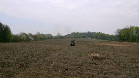 Old tractor plowing field Stock Footage 97716034