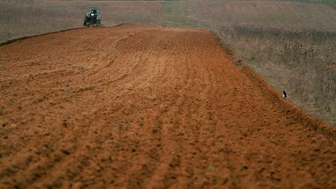 Old tractor plowing field Stock Footage 97757856
