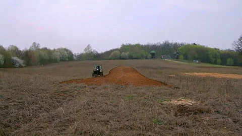 Old tractor plowing field Stock Footage 98052216
