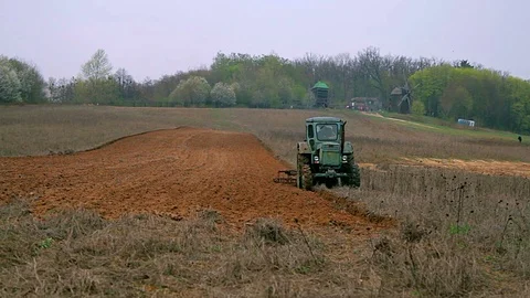Old tractor plowing field Video stock 98756330
