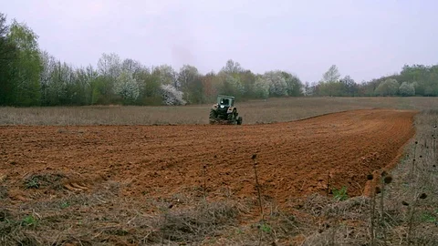 Old tractor plowing field Stock Footage 99000994