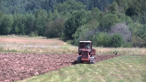 Old tractor plowing the soil. Farmer Stock Footage 85344103