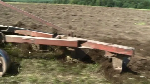 Old tractor plowing the soil. Farmer Stock Footage 85382866