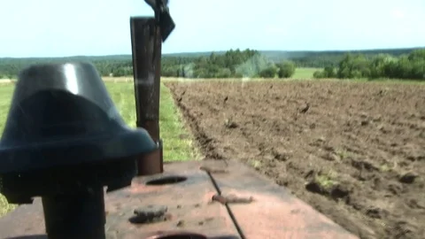 Old tractor plowing the soil. Farmer7 Stock Footage 85382063