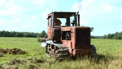 Old tractor plowing the soil. Farmer8 Stock Footage 85382378