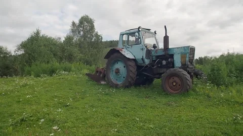 An old tractor stands in a field. Stock Footage 255069346