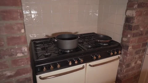 Old traditional kitchen fire with copper ignition knobs. Pan and pot on 스톡 동영상 148313369
