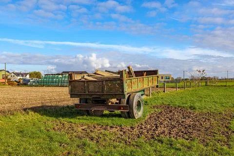 Old trailer car with construction material on agricultural plot Fotos de archivo