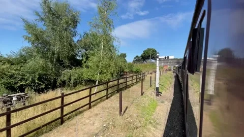 Old Train Approaches a Station in the UK Stock Footage 201964007