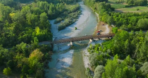 Old Train Bridge spanning over River in Italy. Aerial view of Train Tracks Stock Footage 203280337