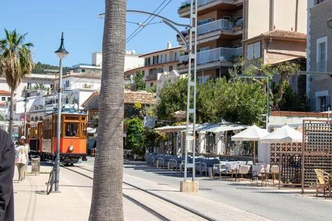 An old train chugs through the bustling city center Stock Photos