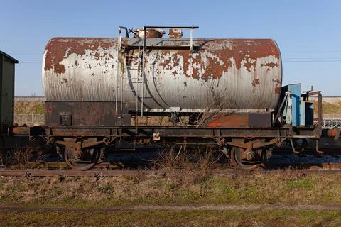 Old train cistern tank wagon, rusty and weathered on abandoned train tracks Stock Photos