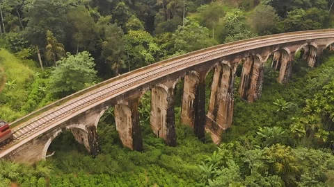 Old train crossing big nine arch bridge in Ella, Sri Lanka, aerial shot. Stock Footage 114621440