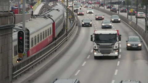 Old train passing traffic in slow motion, Centralbron in Stockholm Stock Footage 143273180