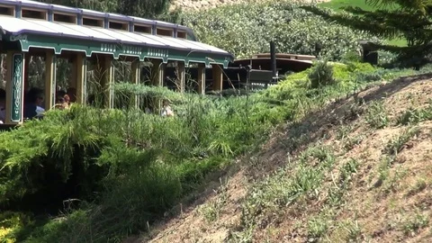 Old train ride on an amusement park going into a tunnel Vídeos de archivo 69734604