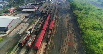Old train yard long out of commission in rural setting 4K aerial Stock Footage 85953100