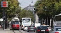 Old Tram Approaching Vienna Rush Hour Traffic Tour Bus Cars Passing Busy Streets HD Footage