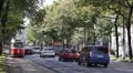 Old Tram Approaching Vienna Rush Hour Traffic Cars Passing Busy Street Commuters HD Footage