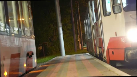 Old tram is coming to station, tilted shot, headlights on Stock Footage 310172231