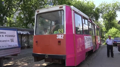 Old trams running near a stop in rural style street Stock Footage 64638798