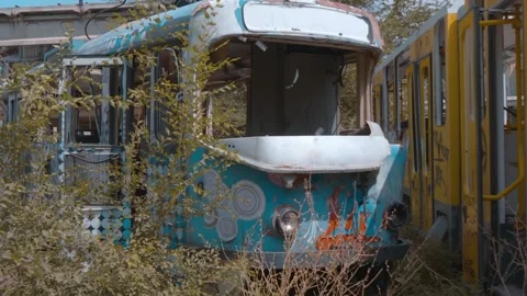 Old trams stand in the depo without windows and decorated of colorful graffiti Stock Footage 318730721