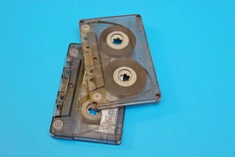Old transparent audio cassettes located on a blue background Stock Photos
