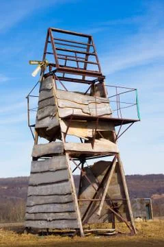 Old triangular metal structure upholstered wooden board stands in mountains Stock Photos