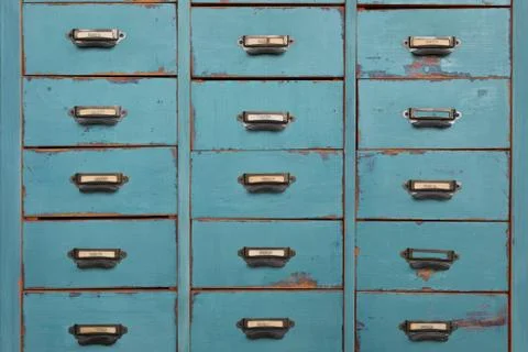 Old turquoise and brown colored wooden cabinet with drawers background Stock Photos