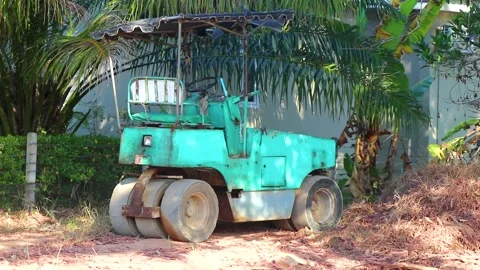 Old turquoise blue steamroller parked and unused in Thailand. Stock Footage 304682270