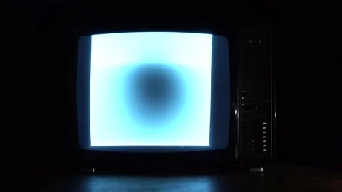 Old TV with reflection on the table, hand of a man turns off the tv Stock Footage 149753436