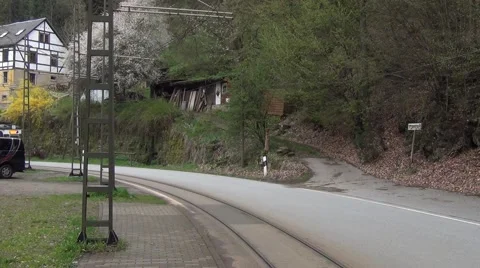 Old two-car yellow tram arrives to the Mittelndorfer Mühle stop Stock Footage 64755181