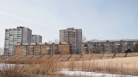 Old type five floor brick houses, yellow and beige colors, near sand beach Stock Footage 127387412