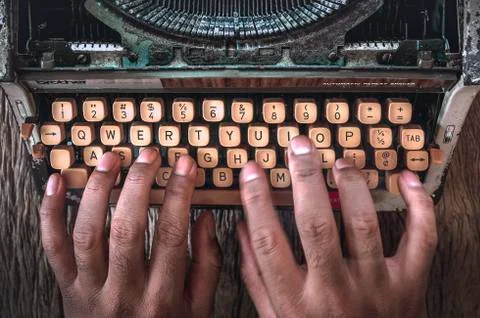 Old typewriter with hand of man typing isolated Stock Photos