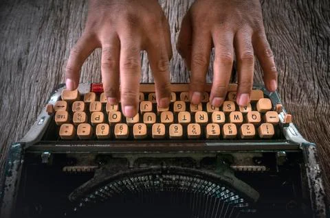 Old typewriter with hand of man typing isolated Stock Photos