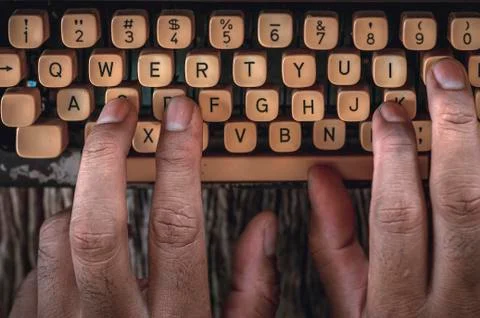 Old typewriter with hand of man typing isolated Stock Photos