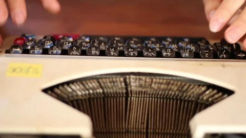 Old typewriter A typewriter used by the man's hand, seen from the side, using Stock Footage 87262691