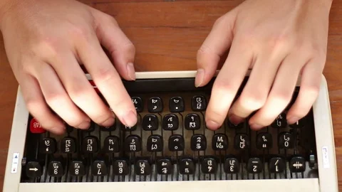 Old typewriter A typewriter used by the man's hand, seen from the side, using Stock Footage 87262796