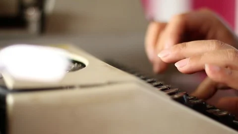 Old typewriter A typewriter used by the woman's hand, seen from the side, usi Stock Footage 85563405