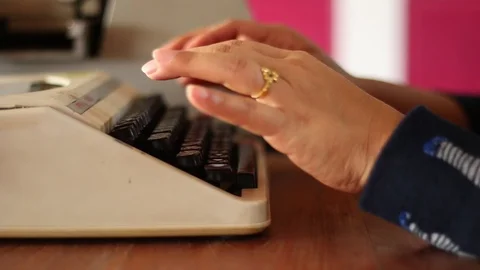 Old typewriter A typewriter used by the woman's hand, seen from the side, usi Stock Footage 85563595