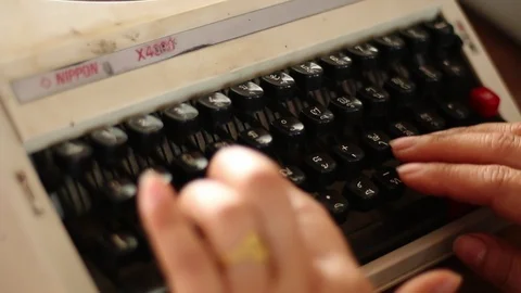 Old typewriter A typewriter used by the woman's hand, seen from the side, usi Stock Footage 87262514