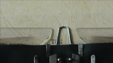 Old typewriter writes text "The End" on a piece of old paper. Stock Footage 143640612