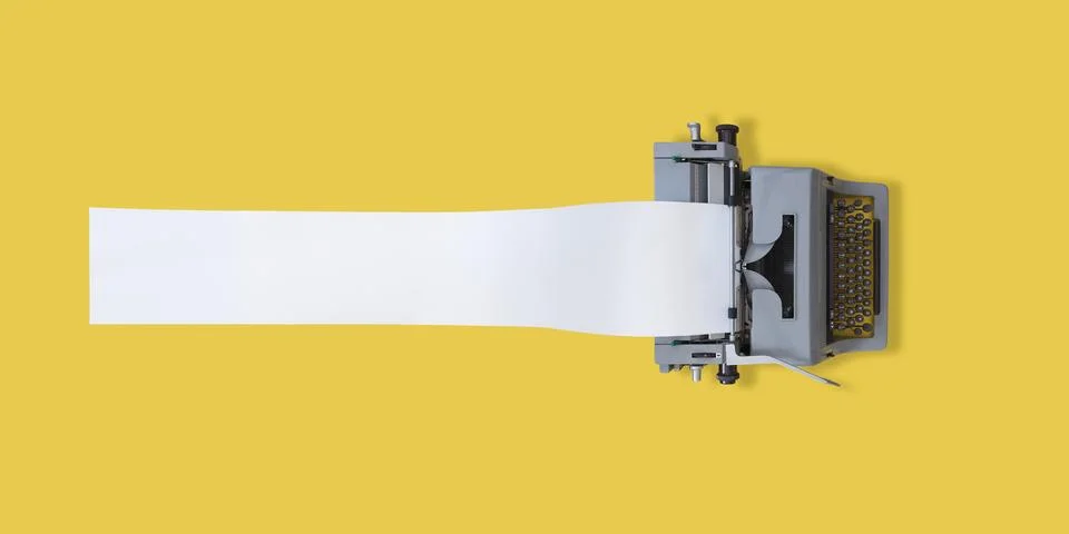 Old typewriter on yellow background Stock Photos