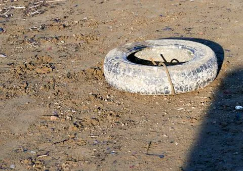 Old tyre on the beach Stock Photos